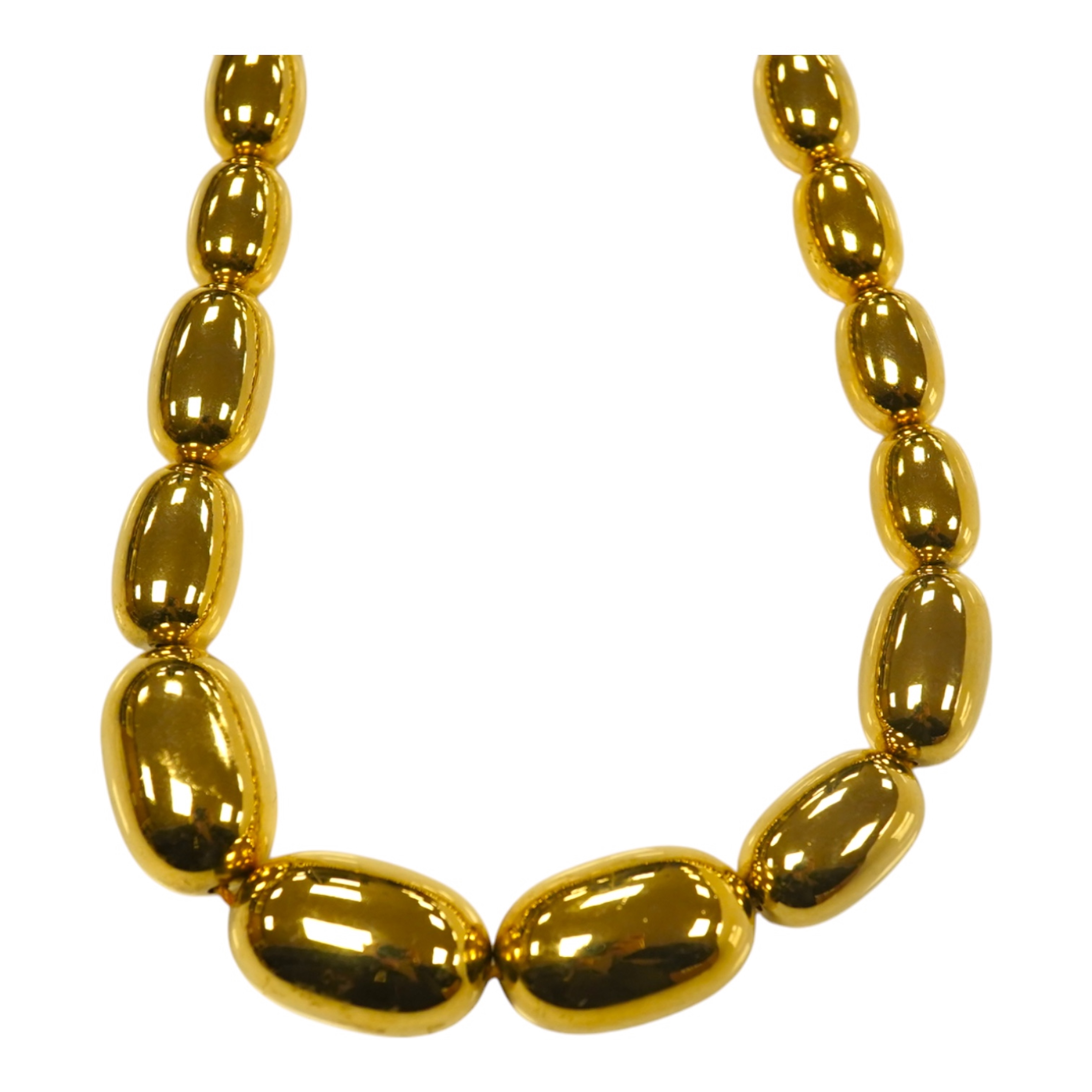 A modern gilt metal graduated oval bead costume necklace, 72cm. Condition - fair to good